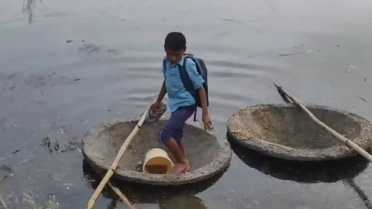 Flood Forces Two Brothers to Use Trough as Boat for School Flood Forces Two Brothers to Use Trough as Boat for School
